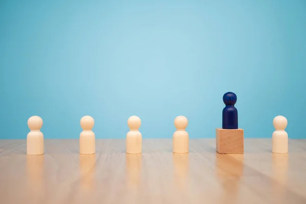 Wooden figure standing on the box for show influence and empowerment. Concept of business leadership for leader team, successful competition winner and Leader with influence