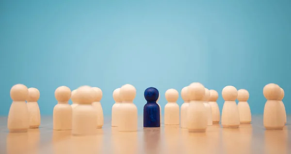 Wooden figure standing with team to show influence and empowerment. Concept of business leadership for leader team, successful competition winner and Leader with influence