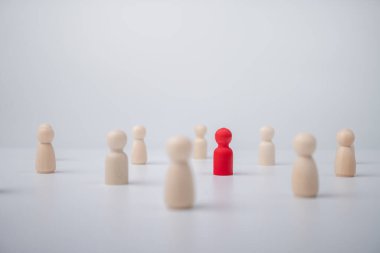 Etkilemek ve güçlendirmek için bir ekiple birlikte duran tahta bir figür. Liderlik kavramı, başarılı yarışma galibi ve yeni normal bir yaşam tarzı için nüfuzlu ve sosyal mesafeli lider.