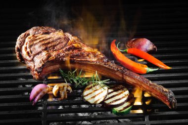 Tomahawk rib beef steak on grill clipart