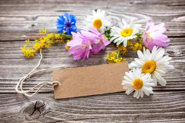 Vilda blommor med en vintage tagg — Stockfoto