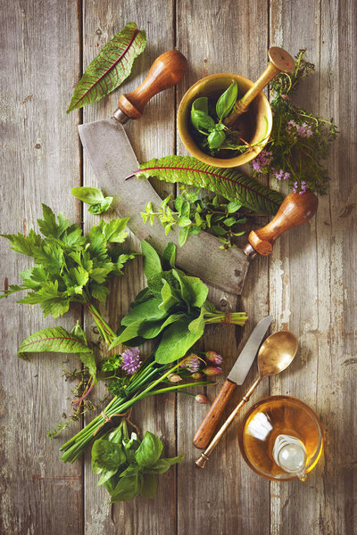 fresh herbs and spices on wooden table