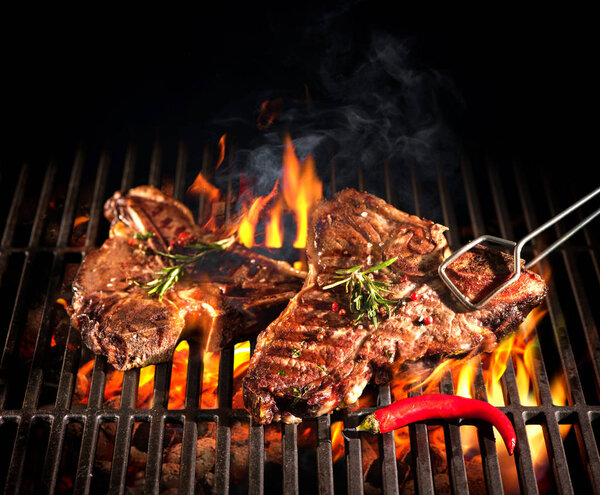 Beef T-bone steaks on the grill Stock Photo