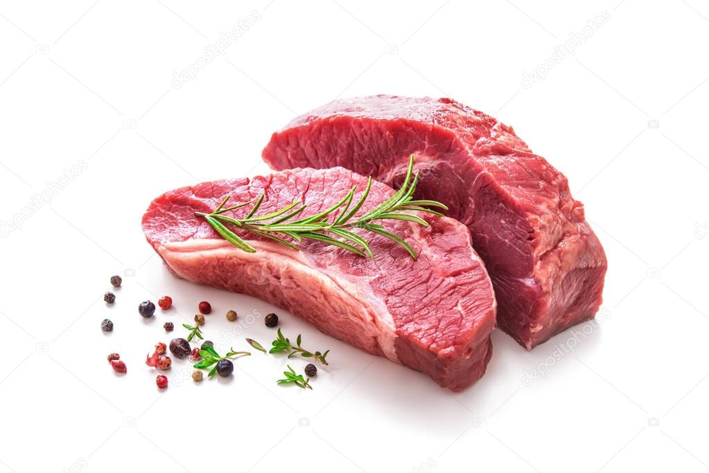 Pieces of raw roast beef meat with ingredients