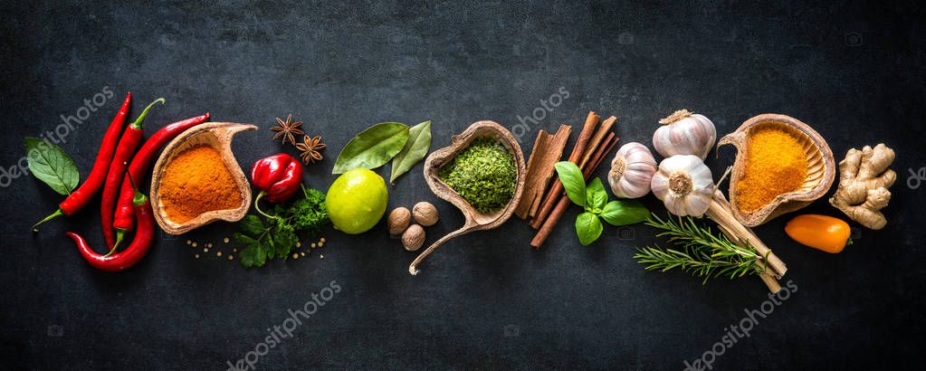 Various herbs and spices on dark background