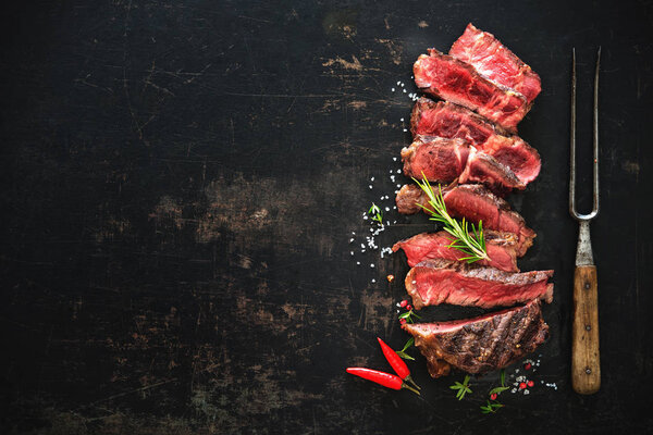 Sliced medium rare grilled beef ribeye steak