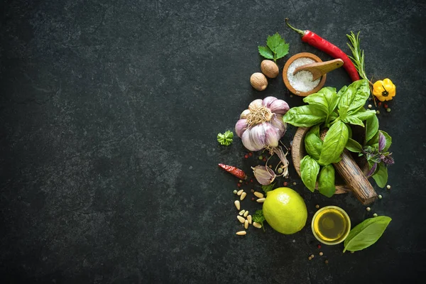 Herbs and spices on black stone table — Stock Photo, Image