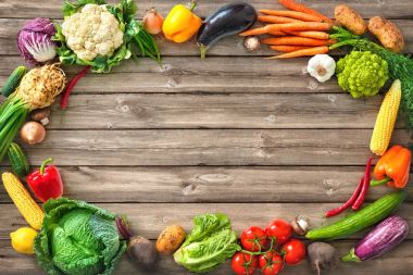 Fresh vegetables on wooden background clipart