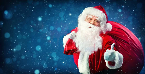 Père Noël avec un sac plein de cadeaux — Photo