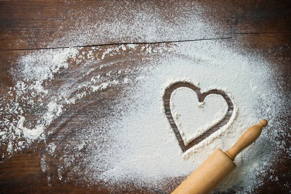 Baking background with the rolling pin, heart shape and flour on — Stock Photo, Image