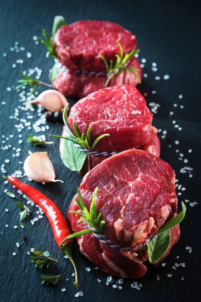 Bifes de filé de carne crua mignon no fundo escuro — Fotografia de Stock