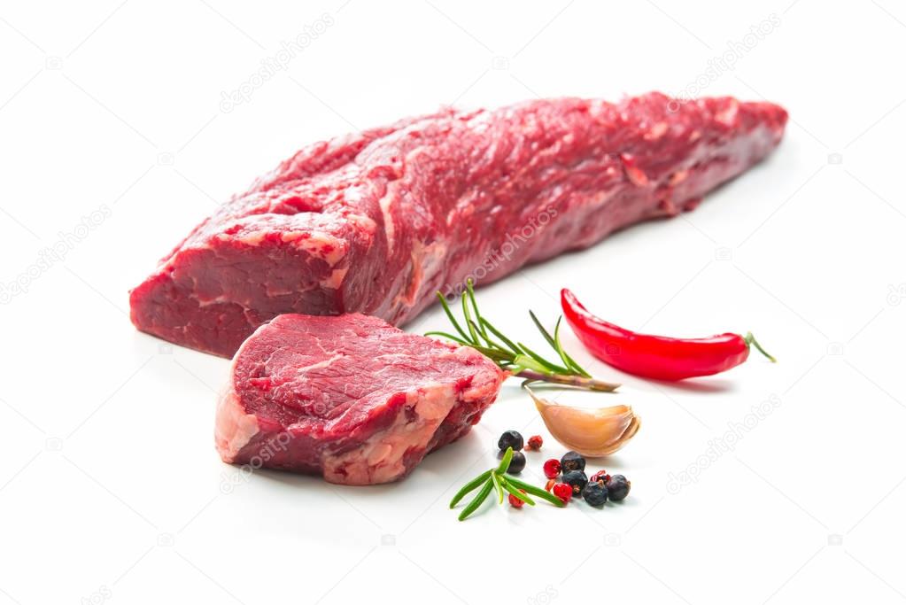 Whole piece of tenderloin with steaks and spices ready to cook i