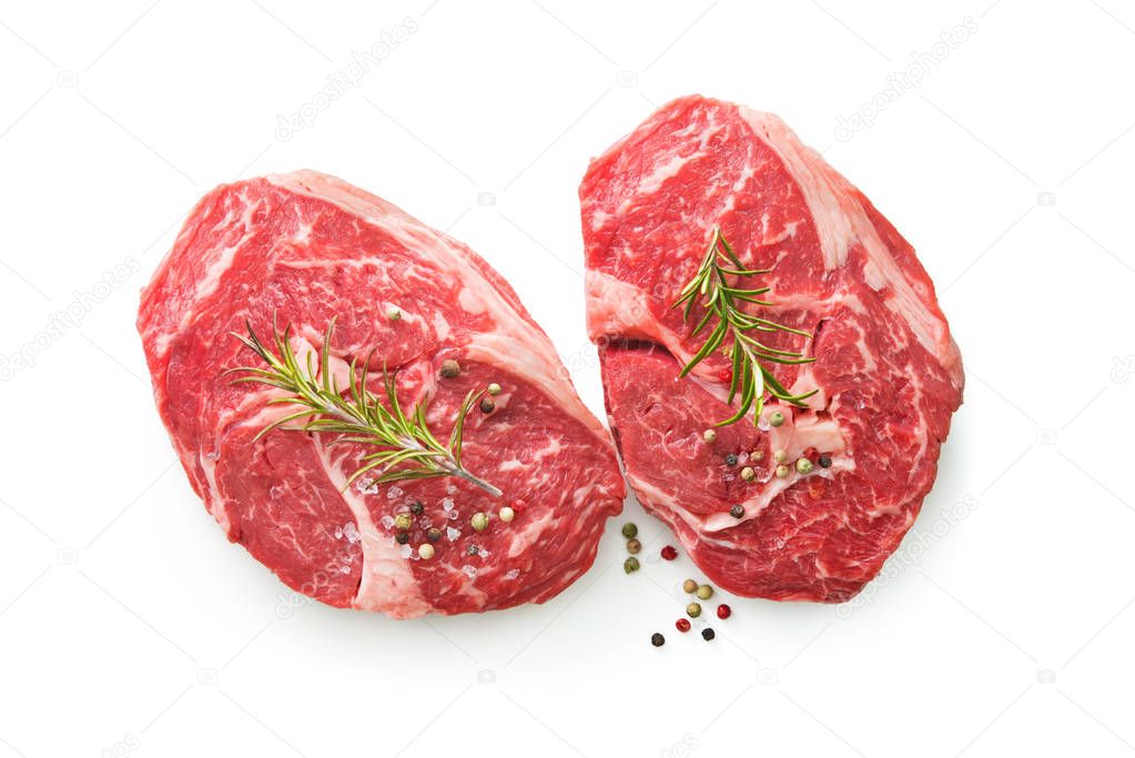 fresh raw rib eye steaks isolated on white background