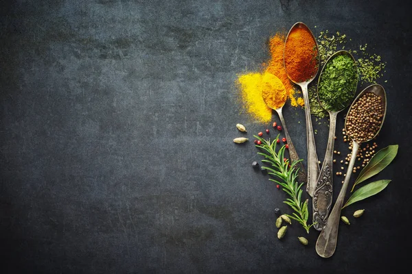 Various herbs and spices on dark background — Stock Photo, Image