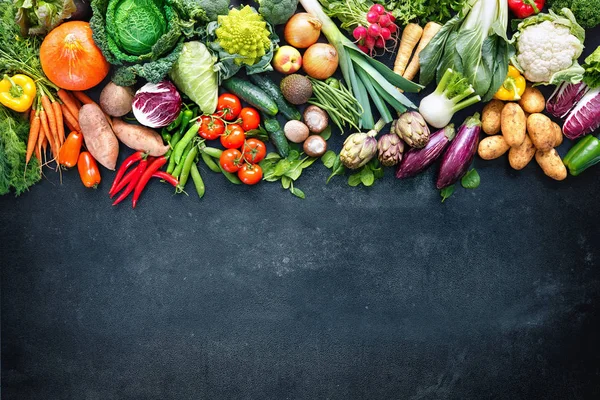 Food background with assortment of fresh organic vegetables