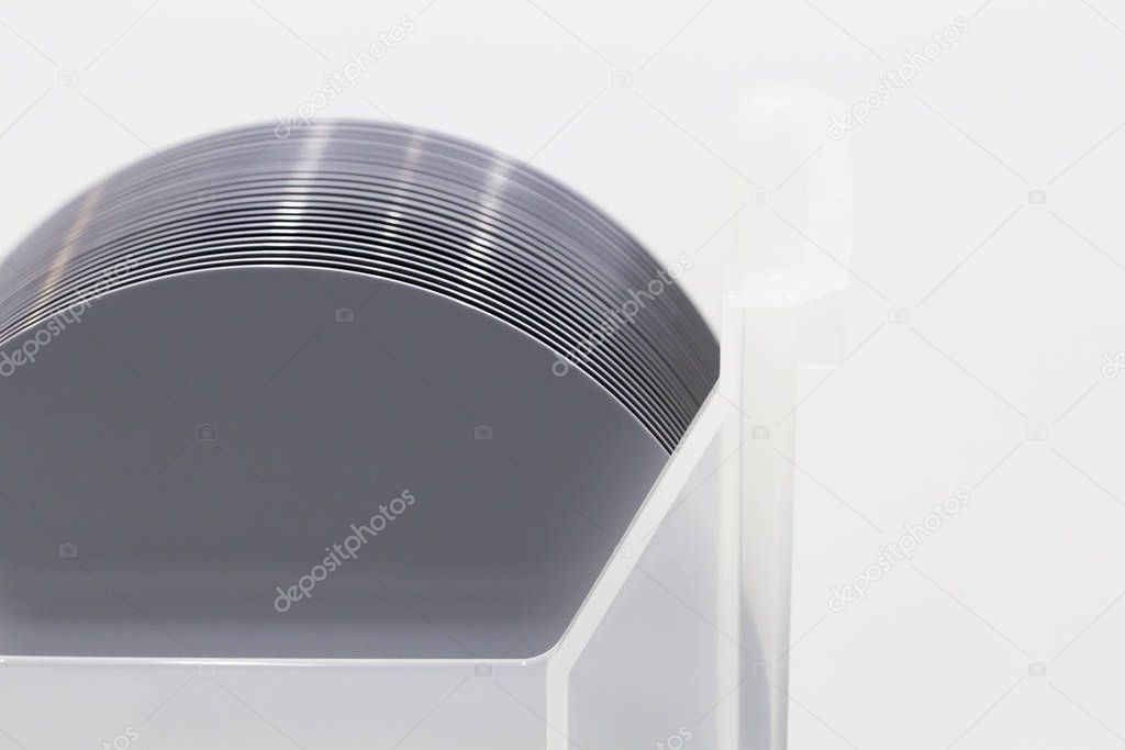 Pieces of polycrystalline silicon on a polysilicon wafer with microchips.