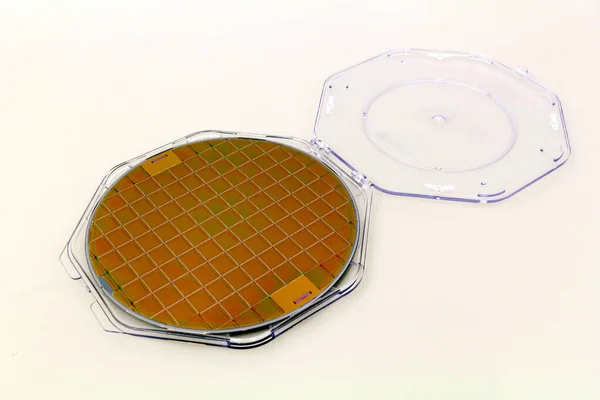 Galettes de silicium dans une boîte de support en plastique sur une table- Une galette est une mince tranche de matériau semi-conducteur, comme un silicium cristallin, utilisé en électronique pour la fabrication de circuits intégrés . — Photo