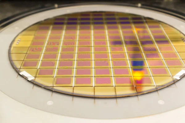 Silicon wafer with microchips fixed in the holder is on the chuck and ready for process cleaning.