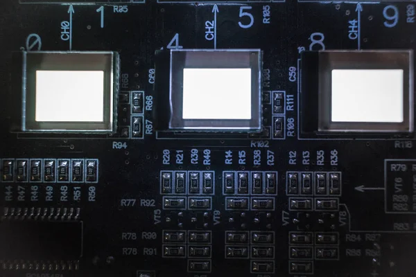 The process of checking several oled displays on the test station. Displays glow brightly.