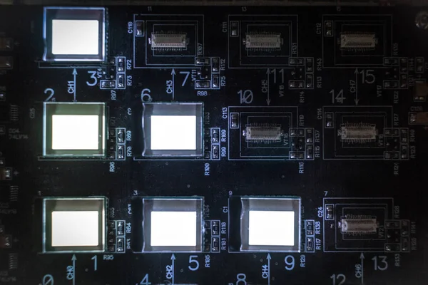 The process of checking several oled displays on the test station. Displays glow brightly.