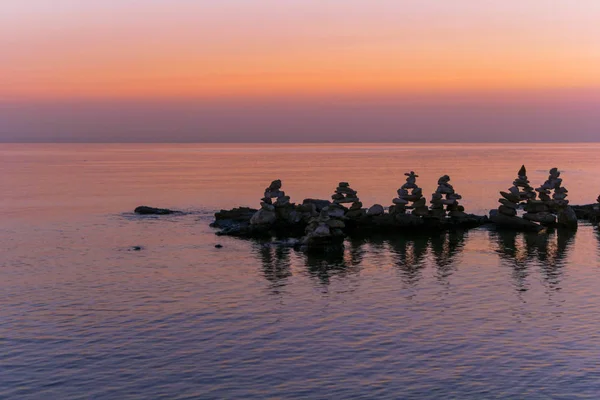 Relajante puesta de sol de mar rosa con piedras . — Foto de Stock