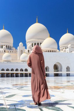 Abu Dabi, Uae - 11 Mart 2019: Şeyh Zayed Camii 'nde geleneksel kahverengi elbiseli kadın. Abu Dabi, Birleşik Arap Emirlikleri.