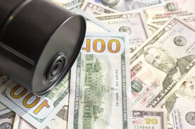 Arka planda petrol varili, Amerikan doları geçmişi. Fıçı fiyatlarındaki düşüş kazançta ve küresel ekonomide azalma eğilimi. Seçici odak.