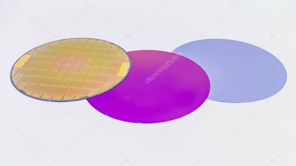 Silicon Wafers three types -empty grey wafer,purple wafer with SiO film and gold wafes with microchips.Several pieces of wafers with microchips.Rainbow on silicon wafers.Color silicon wafers with glare.
