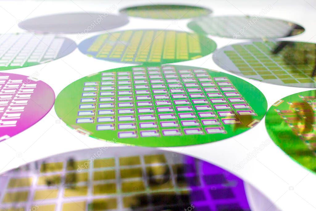Many Silicon Wafers three types - color wafes with microchips.Several pieces of wafers with microchips.Rainbow on silicon wafers.Color silicon wafers with glare.