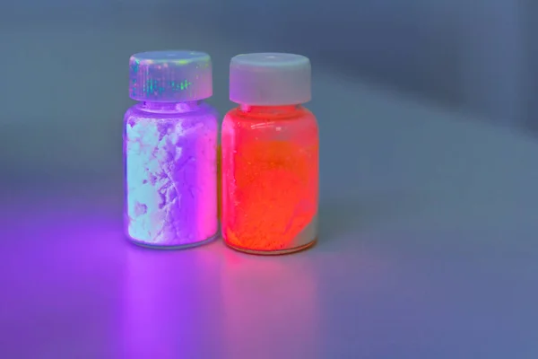 Photoluminescence chemical materials, called fluorescent. Powder glows in the dark under UV light radiation of different colors.