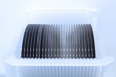 Empty silicon wafers grey color storage in plastic box, prepared for microchip production clipart