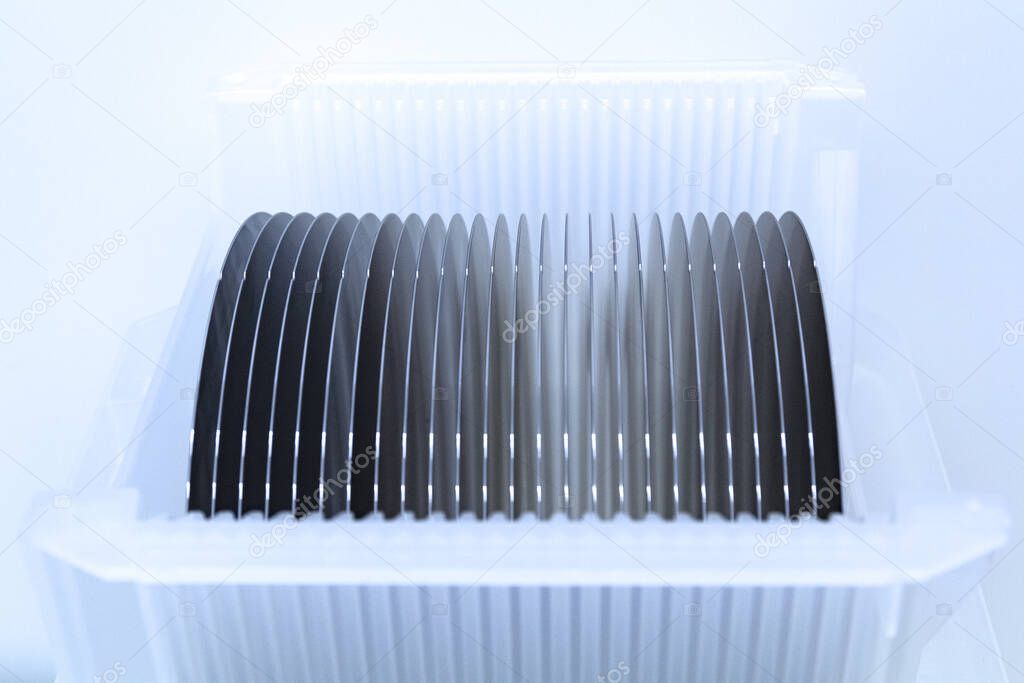 Empty silicon wafers grey color storage in plastic box, prepared for microchip production