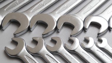 Spanners. Bir sürü anahtar. Gri arka plan. Gri arka planda farklı boyutlarda anahtarlar. Üst Manzara. Kapat..