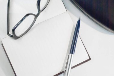 kalem, gözlük ve not defteri