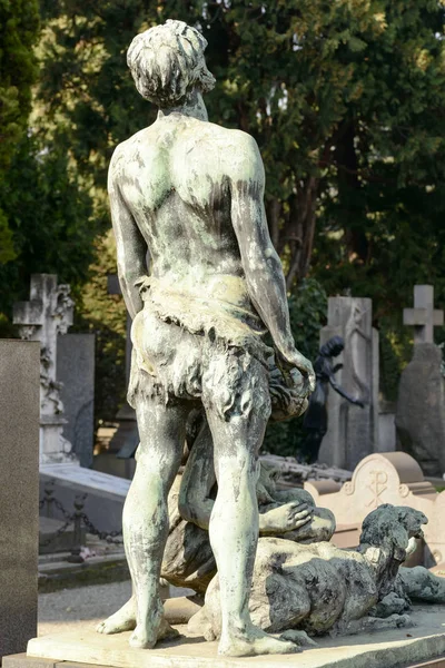 back of man bronze sculpture at Monumental Cemetery, Milan