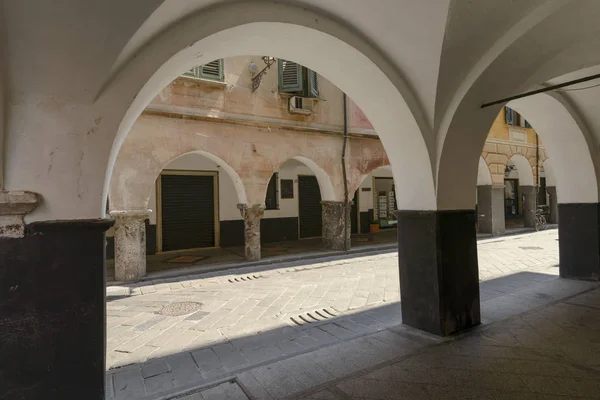 facing arches and pillars of medieval covered walkway, Chiavari