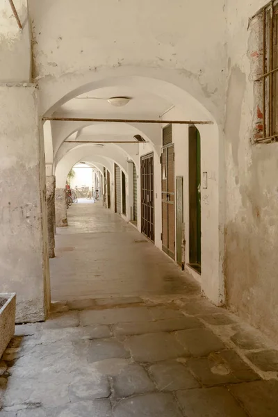under medieval covered walkway, Chiavari , Italy