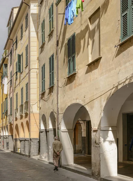 old houses with covered walkway in narrow street at street marke