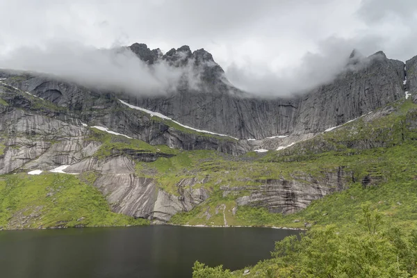 Penhascos de rocha íngremes nas águas do lago, no lago Stor, Lofoten, Noruega — Fotografia de Stock