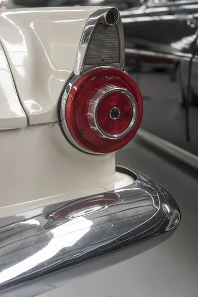 detail of chrome plated fin with round rear light and shining bumper of vintage 50's car. shot at Wanaka, Otago, South Island, New Zealand