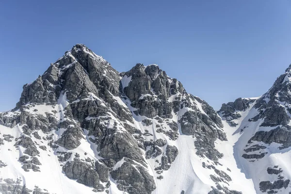 aerial, from a glider, of steep dark summits at Mt.Head range with spring snow, shot in bright spring light from north-east, Otago, South Island, New Zealand