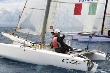 PUNTA ALA - 3 JUNE: athletic men on sail boat during Formula 18 national catamaran regatta, on June 3 2016 in Punta Ala, Italy clipart