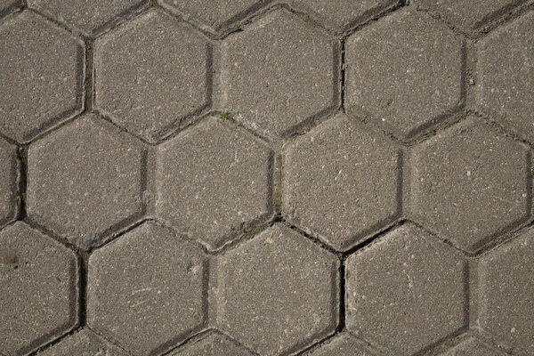 The texture of the paving slab. Hexagonal form