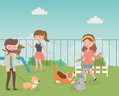 Tarlada küçük sevimli köpekleri olan genç insanlar.