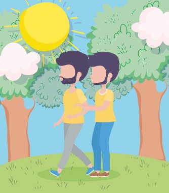 Genç erkekler çayır ağaçlarının güneşi altında yürür.