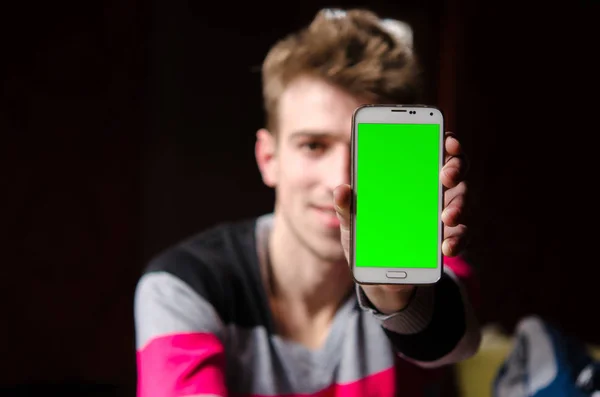 De jonge man toont zijn financiële evenwicht op uw mobiele telefoon. Stockfoto