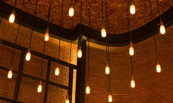 Decorative antique edison style light bulbs against brick wall b — Stock Photo, Image
