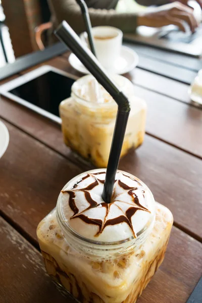 Coffee, ice coffee on table wood background in cafe, in front o — стоковое фото