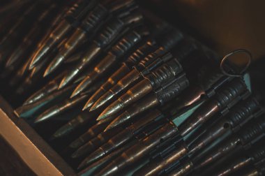 The cartridge belt loaded with cartridges lies in the box. Milit