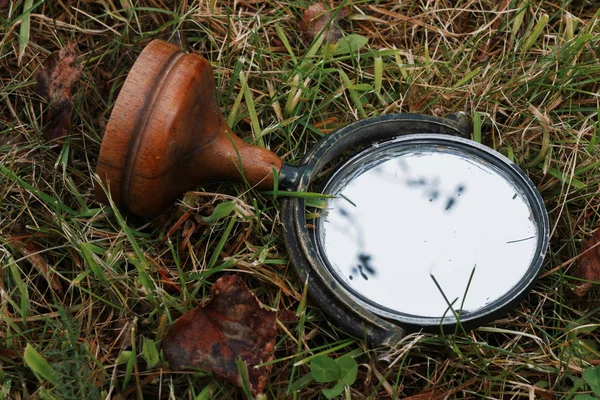 An old mirror on the grass